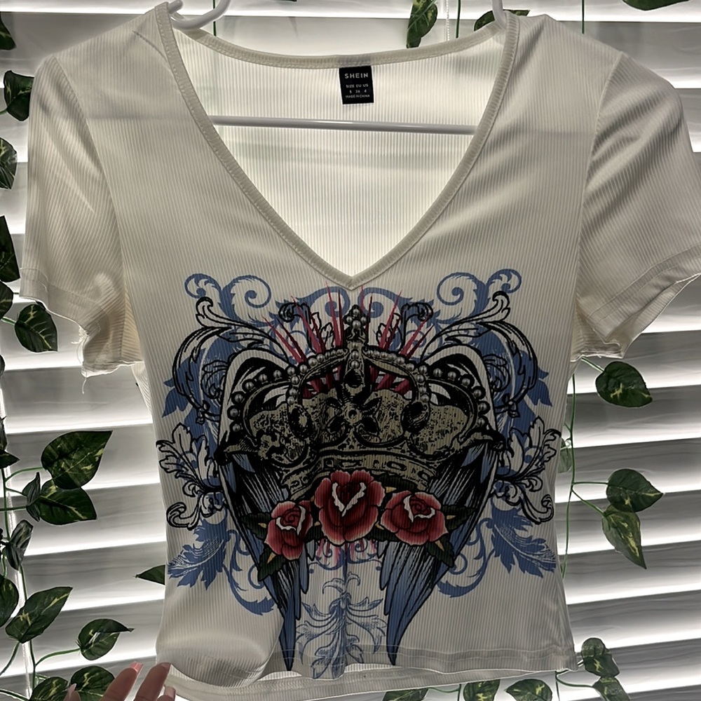A white V Cut top with a colorful design